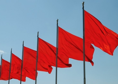 Five red flags on poles waving in the wind. (Photo: iStock)