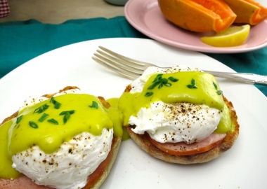 eggs benedict on a plate topped with green matcha sauce. (Photo: My Lilikoi Kitchen)