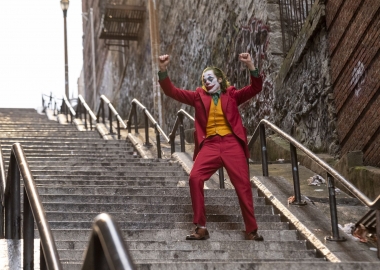 Joker dances on a long flight of outside steps. (Photo: Warner Bros. Pictures)
