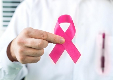 Doctor holding pink breast cancer awareness ribbon. (Photo: iStock)