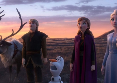 Sven, Kristoff, Olaf, Anna and Elsa standing in a grassy field looking up at something outside the picture. (Photo; Walt Disney Studios)