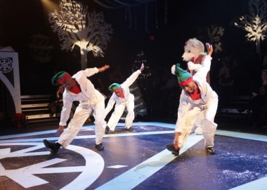 Dancers dressend as elves perform with a life-size polar bear. (Photo: Step Afrika!)