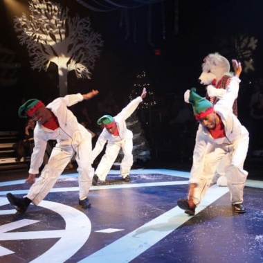 Dancers dressend as elves perform with a life-size polar bear. (Photo: Step Afrika!)