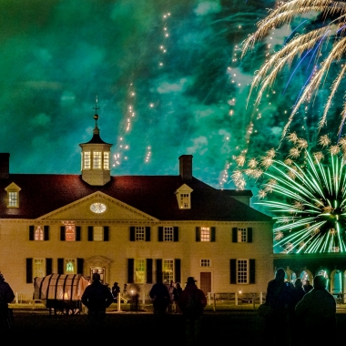 People standing outside in front of the Mount Vernon mansion at night watching fireworks. (Photo: Mount Vernon)