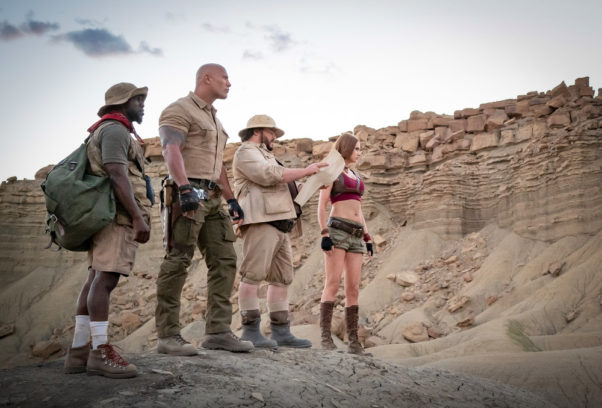 Kevin Hart, Dwayne Johnson, Jack Black and Karen Gillan standing in the dessert looking to the right. (Photo: Sony Pictures)