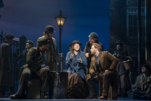 The cast of My Fair Lady gathered around Elizza Doolittle as she sings. (Photo: Johan Persson)