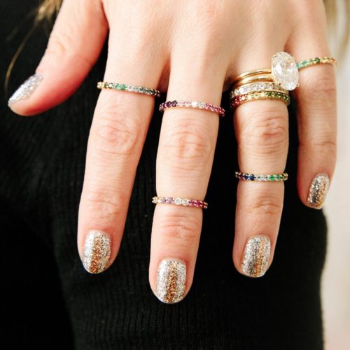 Woman with gold glitter on her nails and multiple rings on her fingers. (Photo: Paintbox/Instagram)