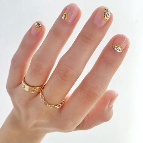woman showing 4 fingers...each with gold glittler in just a tiny patch in a different spot. (Photo: Betina R. Goldstein/Instagram)