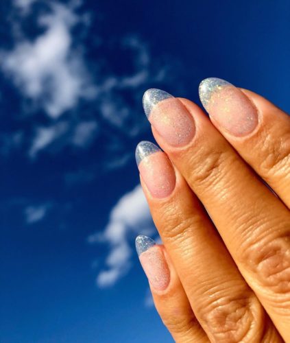 Woman with silver glitter on the tips of her nails and clear glitter on the rest. (Photo: Michelle Humphrey/Insagram)