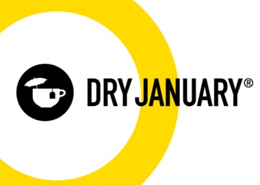 Dry January black & yellow logo with a tea cup holding a tea back and a cocktail umbrella. (Graphic: Alcohol Change UK)