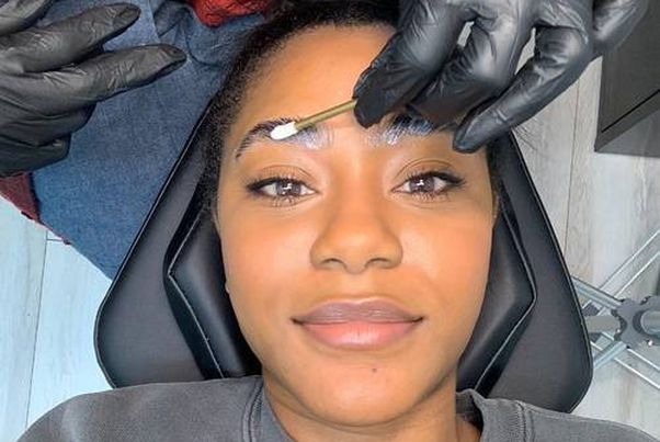 Eyebrow specialist Aja Vines applies laminating cream to the author's eyebrows. (Photo: Hyperreal Brows)