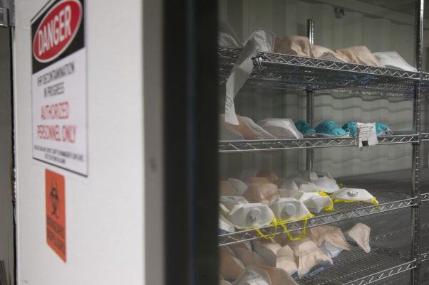 N95 hospital masks are stacked on shelves inside a shipping container converted for sterilization April 17, 2020, in Waukegan, Ill. (Photo: Stacey Wescott/Chicago Tribune)