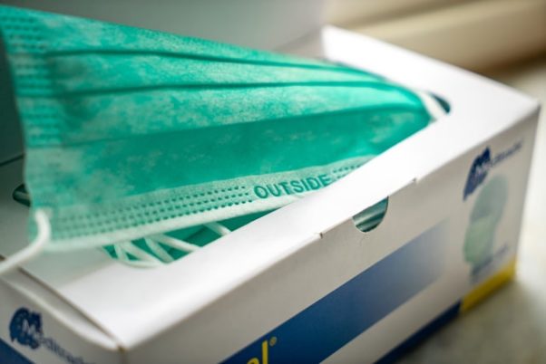 A box of surgical masks. (Photo: MIka Baumeister/Unsplash)