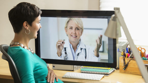 Woman video chatting with a female doctor. (Photo: Getty Images)