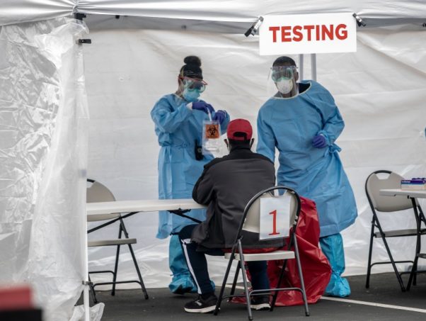 A man gets tested at a CORE walk-up test site in San Jose, Calif., on May 20, 2020.</p>
<p id=