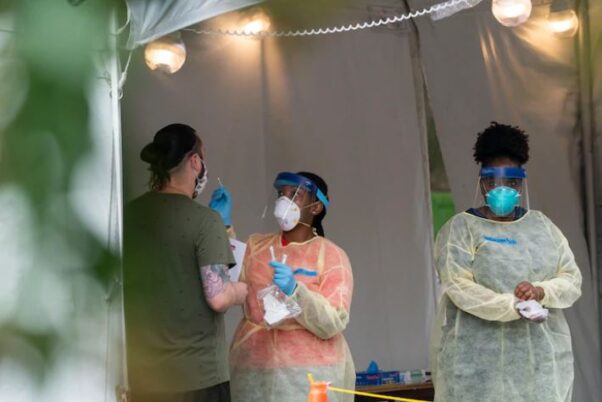 A D.C. Health nurse admistiers a test Aug. 14 at the Judiciary Square test site. (Photo: Alex Brandon/AP)