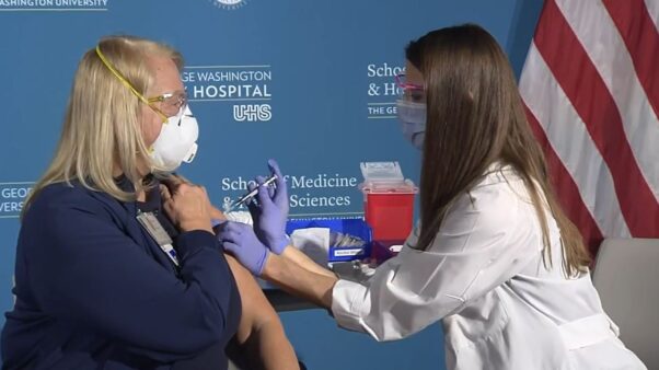 Emergency department nurse Barbara Neiswander gets the first COVID-19 vaccination in D.C. at George Washington University Hospital on Monday. (Photo: Screen Caputre/HHS)