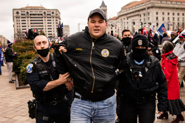 U.S. Park Police officers arrest an unmasked man on gun charges after officers spotted him carrying a concealed firearm during a pro-Trump rally at Freedom Plaza on January 5, 2021. (Photo: Samuel Corum/Getty Images)