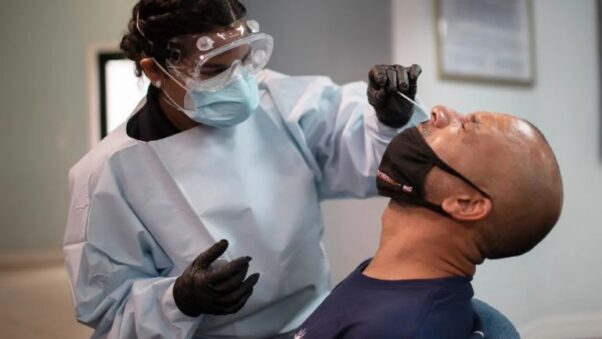 A Black man gets a COVID-19 nasal swab in Pembroke Park, Fla. (Photo: Consumer Reports)