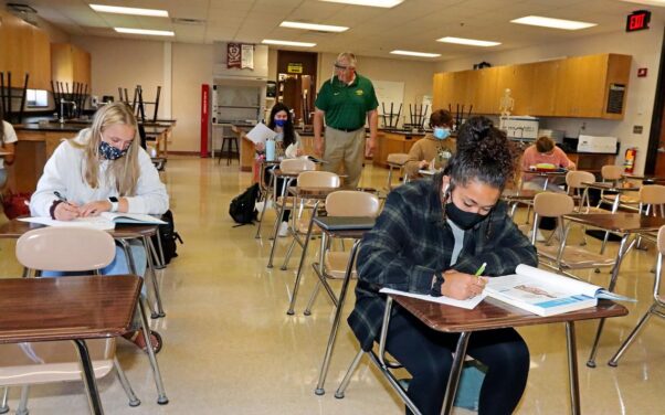 Students in a biology class at Crosby-Ironton High School in Brainerd, Minn., wear masks while sitting as socially distanced desks on Sept. 3, 2020. (Photo: Kelly Humphrey/Brainerd Disptach)