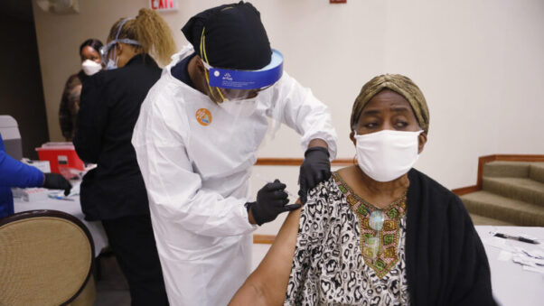 An elderly Black woman gets a COVID-19 vaccination at St. John's Missionary Baptist Church in Tampa, Fla. (Photo: Octavio Jones/Getty Images)