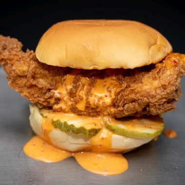 Fuku's spicy friend chicken sandwich with pickles and sauce (Photo: Clay Williams>