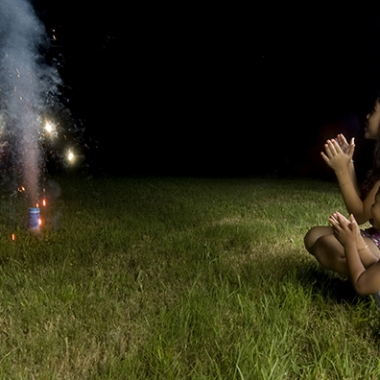 Two children squatting down watching sparks shoot into the sky from fireworks. (Photo: Two children squatting down watching sparks shoot into the sky from fireworks. (Photo: Shutterstock)Shutterstock)
