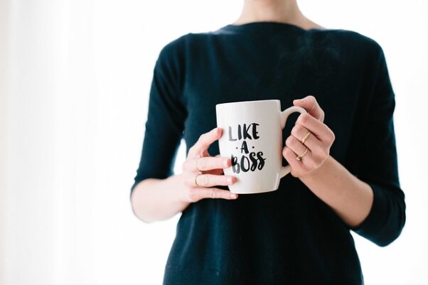 Woman holding a coffee mug that says "Like a Boss". (Photo: StockSnap/Pixabay)