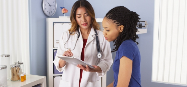 A young black woman in a female doctor's office. (Photo: USC)