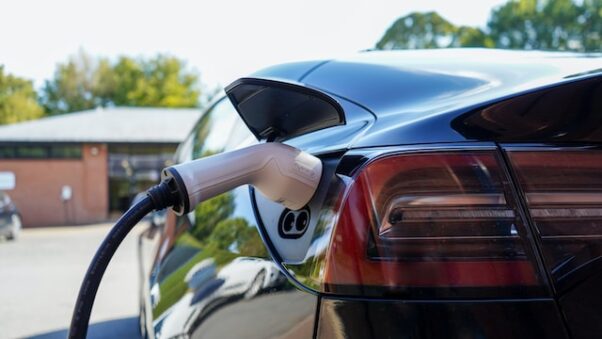 An electric car being charged outside in winder. (Photo: My Energi/Unsplash)