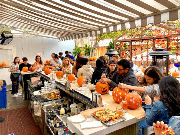 Patrons sitting at the bar decorate pumpkins at Calico's annual Fall Harvest Festival last year. (Photo: Calico)
