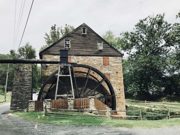 Exterior of the stone and wood Rock Run Grist Mill showing the water wheel. (Photo: Eric Brouillette/Shutterstock)