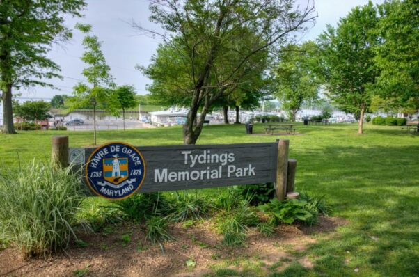 Entrance to tyding's memorial park with a sign in the forefront and the waterfront in the background. (Photo: Maryland Office of Tourism)