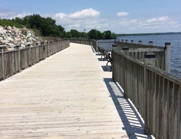 The Havre de Grace Promenade wooden boardwalk with a railing and benches along the water.  (Photo: Marcia Smith)a