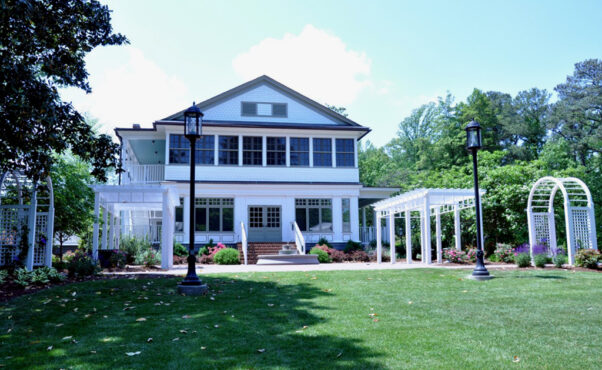 The rear patio of Armour House with arches and pergolas on both sides and the white house in the background. (Photo: Henrico County)