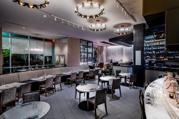 The refreshed Karizma interior with a gray and blue palate, dark wooden chairs and marble topped tables. (Photo: Karizma)
