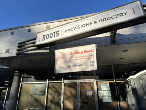 Exterior of Roots Provisions & Groceries with a Timber Pizza Coming Soon sign hanging on it. (Photo: Angela Woolsey)
