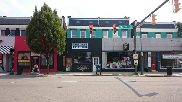 Single-story shops including a tattoo parlor line a street in the Fan Districts in front of Victorian Homes. (Photo: Payton Chung/Flickr)