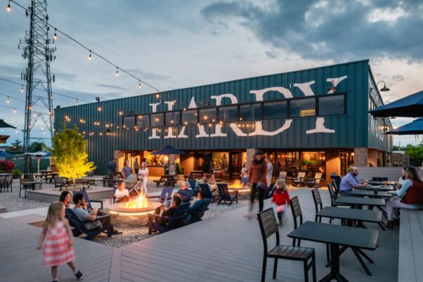 People sit at tables and around two fire pits at Hardywood Park Craft Brewery in the evening. (Photo: Ansel Olsen)