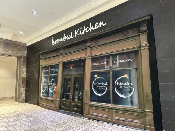 Exterior of Istanbul Kitchen at Tysons Corner Center. The front is brown with white letters at the top and coming soon signs in the four windows. (Photo: Angela Woolsey)