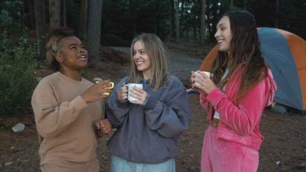Maddie Ziegler (l to r), Maisy Stella and Kerrice Brooks drinking shroom tea from white mugs outside in <em>My Old Ass</em>. (Photo: Prime)
