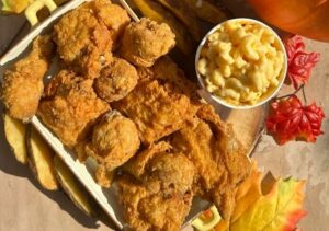 A yellow and white serving dish full of Royal Farms fried chicken beside a white bowl of mac and cheese. (Photo: Royal Farms/Facebook)