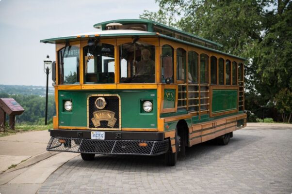 The old-fashioned green and gold Richmond Trolley parked along a street. (Photo: RVA on Wheels)