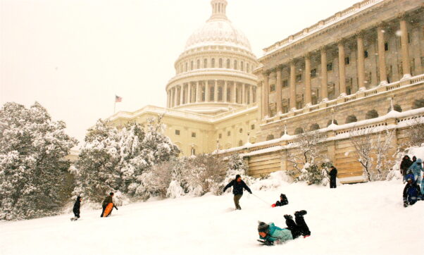 Kids sledding down the hill in front of the U.S. Capitol. (Photo: Val H/Flickr)