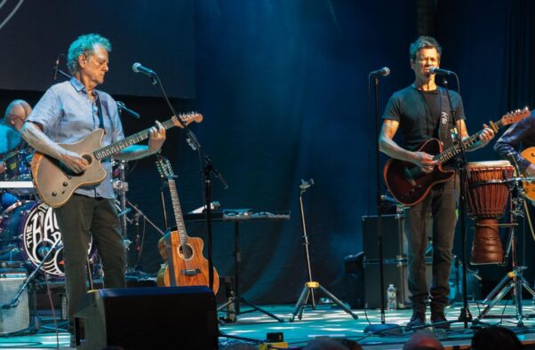 Michael Bacon (left) and Kevin Bacon (right) play guitars on stage during a concert Sept. 20 in Des Plaines, Ill. (Photo: Vanessa Sundra)