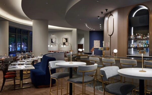 The remodeled bar and dining room with cream and navy blue walls, navy banquettes and brass accents at Trademark restaurant in the Westin Old Town Alexandria. (Photo: Trademark)