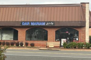 Exterior of Dar Mariam from the road with sign and three half circle windows. (Photo: Dar Mariam)