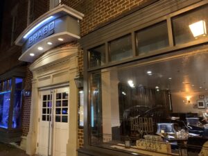 Exterior of Brabo at night with sign above door. (Photo: Cyndy K./Yelp)