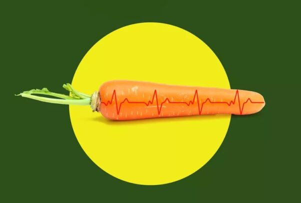 A carrot with ECG lines on a yellow and green background. (Image: Getty Images)