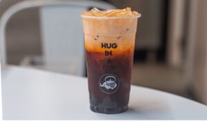 A Thai tea in a Kokee Tea cup sitting on a white table. (Photo: Kokee Tea/Facebook)
